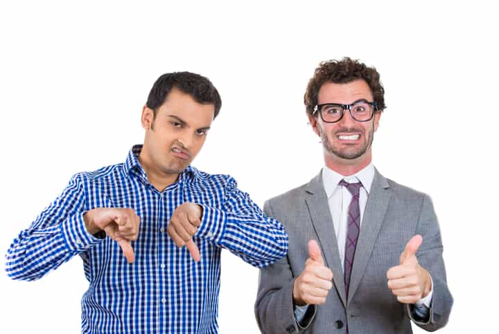 A portrait of two co-workers, a wall street businessman and a main street worker, one being negative and angry, the second one positive and optimistic, isolated on a white background. World polarity